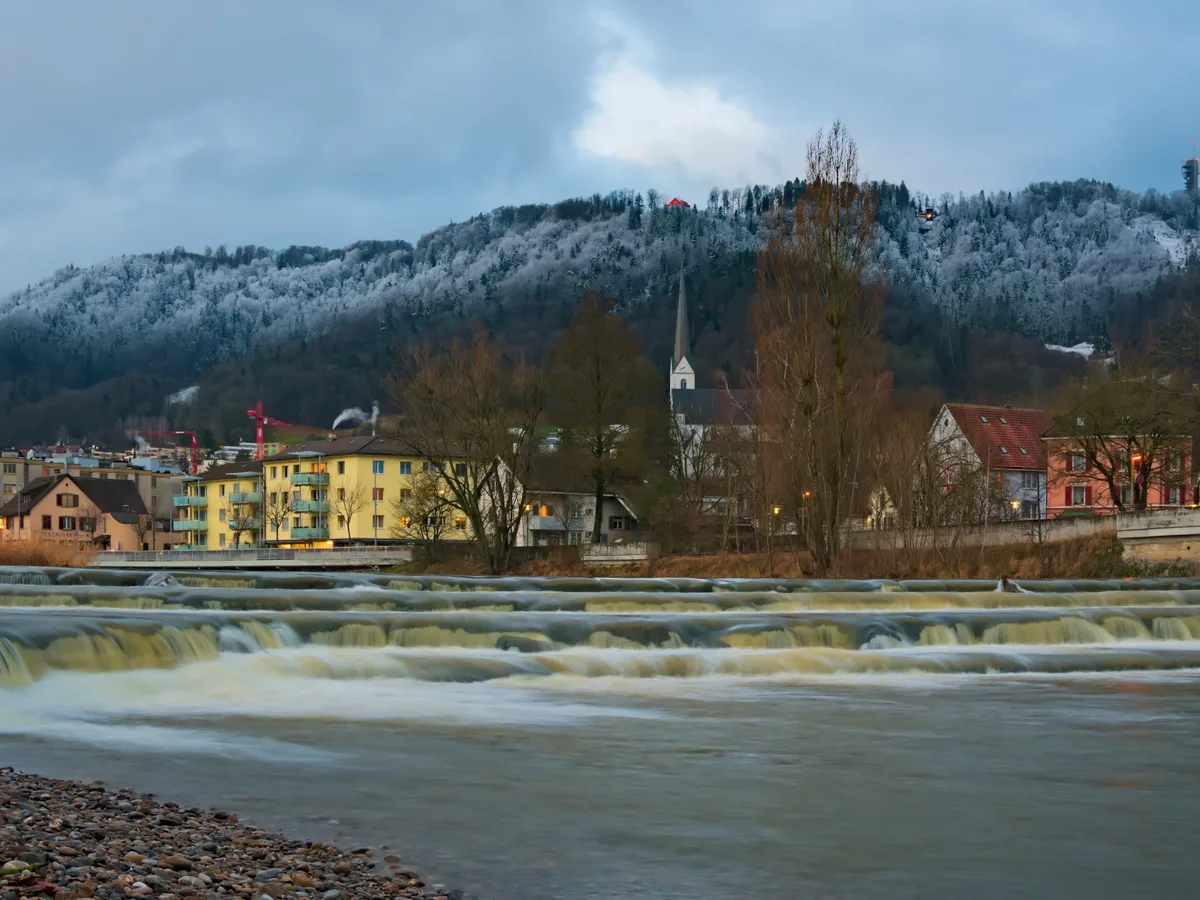 Adliswil townscape on the river Sihl below the wooded Albis and Felsenegg ridge