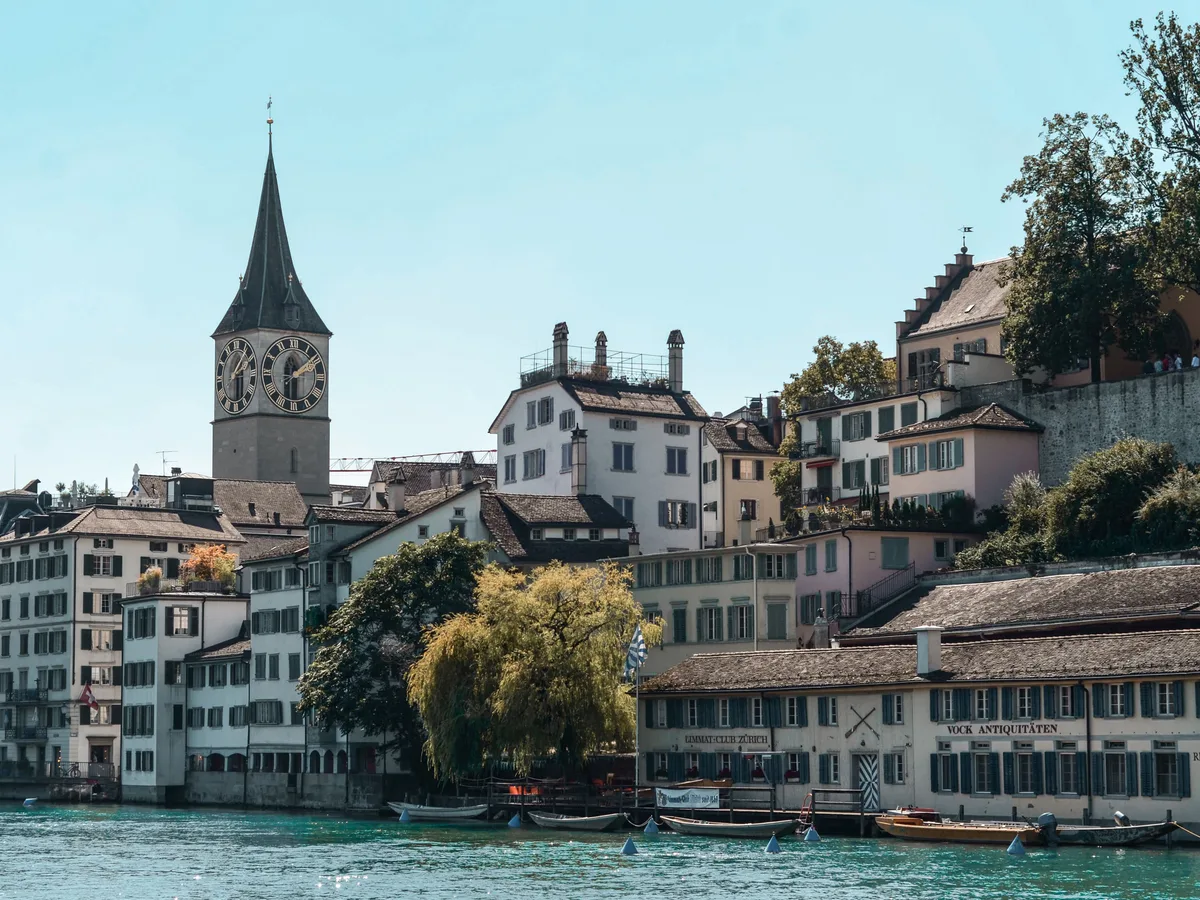 The Limmat riverfront in the old town of Zürich, with the tower of St. Peter above the historic houses